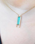 Emerald baguette cut necklace with natural diamonds, 14K yellow gold chain, and unique sliding tube bail.