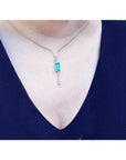 Women's 14K white gold necklace with an elongated Colombian emerald and diamond accents.