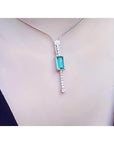 White gold necklace with a rectangular Colombian emerald pendant and diamond accents.