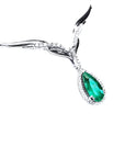 Pear cut emerald necklace sourced from Muzo mines in a halo diamond crafted in 14k white gold.