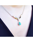 14K white/yellow gold necklace with a pear-shaped Colombian emerald and diamond chevron design.