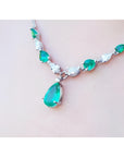 Pear-shaped emerald and diamond necklace in 14k white gold, featuring a large emerald drop.