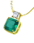 This is a closer side of an Asscher cut emerald pendant necklace with a natural princess cut diamond on top