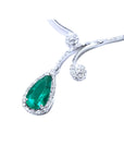 Pear cut deep green emerald necklace with diamond halo and accents, set in 18K white gold.