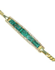 A closer topside view of a five stone natural colombian emerald bracelet with diamonds in yellow gold.