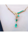 14K yellow gold necklace with marquise and pear shaped Colombian emeralds and diamonds.