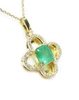 A four-leave clover design natural colombian emerald and diamonds pendant in 14k yellow gold.