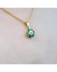 18K yellow gold cluster pendant with natural Colombian emeralds and a center diamond.