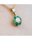 Natural colombian emeralds and diamond cluster pendant necklace in 18k yellow gold.