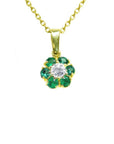 18K yellow gold cluster pendant with a center diamond surrounded by emeralds.