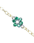 Natural emerald cluster bracelet with center diamond, crafted in 14k white and yellow gold.