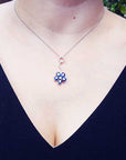 A woman wearing a cluster of natural sapphires pendant white gold necklace on outdoor