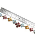 18K white gold necklace with X-cluster links, tri-colored topaz, and diamond, measured by a ruler.