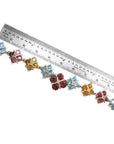 18K white gold necklace with X-cluster links, tri-colored topaz, and diamond, measured by a ruler.