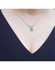 Emerald bow tie necklace, pear-shaped 1.28 ct. deep green emerald, 18K white gold.