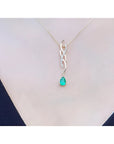 Pear-shaped emerald pendant on a twisted 14K yellow gold slider necklace with diamond accents.
