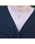 1.01 carat pear cut emerald necklace with accent diamonds and 14K yellow gold V chevron design.