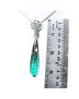 Colombian emerald briolette necklace with a bluish-green drop pendant and diamond slider on 14K white gold chain, next to a ruler.