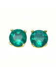Pair of emerald round cut prong set earrings on a front side position, tables and crowns of the gems are clearly visibles