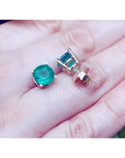 Colombian emerald stud earrings, round cut, bluish-green, in 14K yellow gold prong settings.