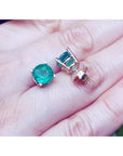 Colombian emerald stud earrings, round cut, bluish-green, in 14K yellow gold prong settings.