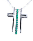 An unassembled white gold cross pendant with natural round emeralds on a white background.
