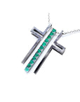 14K white gold cross pendant with prong-set round Colombian emeralds on a delicate chain.
