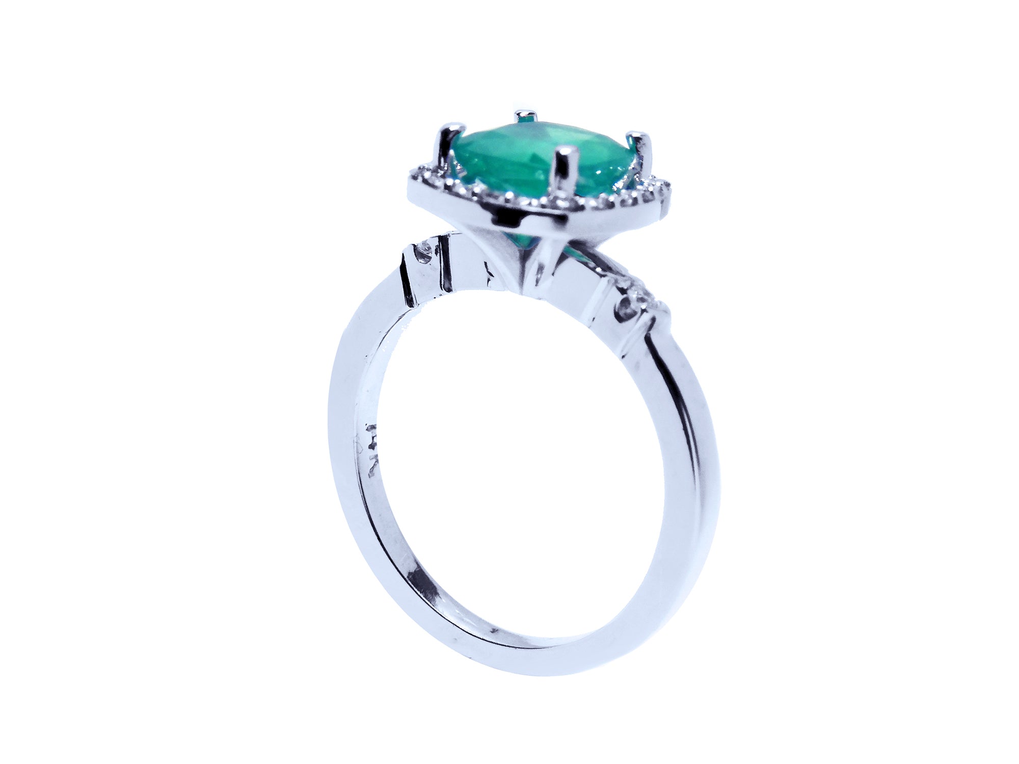 This white gold emerald ring shows the top cushion cut setting and band on a half side position.