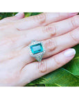 GIA certified 3.98 ct. emerald and diamond ring in 18K white gold, worn on a hand.