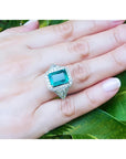 GIA certified 3.98 ct. emerald and diamond ring in 18K white gold, worn on a hand.
