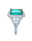 GIA certified 3.98 ct. emerald and diamond ring in 18K white gold with halo and trillion side stones.