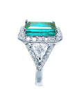 GIA certified 3.98 ct. emerald and diamond ring in 18K white gold with halo and trillion side stones.