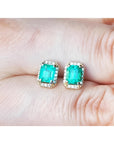 1.41 ct. rectangular Colombian emerald halo stud earrings with diamonds in 14k yellow gold.