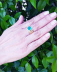 Men's 18K yellow gold ring with a rectangular, medium-deep green emerald in a full bezel setting.