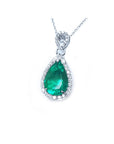 5.83 ct. pear-cut Colombian emerald pendant with diamond halo in 18K white gold.