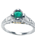 This natural oval cut colombian emerald ring in white gold displays the top and sides profile.