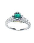 This natural oval cut colombian emerald ring in white gold displays the top and sides profile.