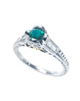 14K white gold ring with a 0.33 ct. oval-cut Colombian emerald and baguette diamond accents.