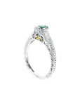 Oval-cut Colombian emerald ring in 14K white gold with baguette diamond accents and intricate filigree.