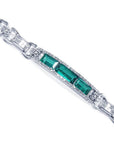 White gold bracelet with three rectangular Colombian emeralds surrounded by princess cut diamonds.