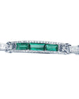 White gold bracelet with three rectangular Colombian emeralds surrounded by princess cut diamonds.