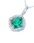 Emerald pendant necklace on a white background left side position.