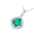 Cushion-cut Colombian emerald pendant with diamond halo in 14K white gold.