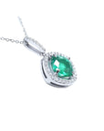 Cushion-cut Colombian emerald pendant with diamond halo in 14K white gold.