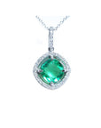 Emerald cushion cut with halo diamond pendant necklace on a topside view.