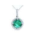 Cushion-cut Colombian emerald pendant with halo diamonds in 14K white gold on a delicate chain.