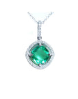 Cushion-cut Colombian emerald pendant with halo diamonds in 14K white gold on a delicate chain.