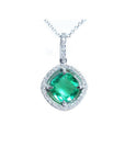 Cushion-cut Colombian emerald pendant with halo diamonds in 14K white gold on a delicate chain.