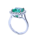 A 18k white gold emerald ring cushion cut showcasing the side top and the profile of the ring band.