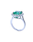 3.69 ct. cushion cut Colombian emerald engagement ring with diamond halo in 18K white gold.
